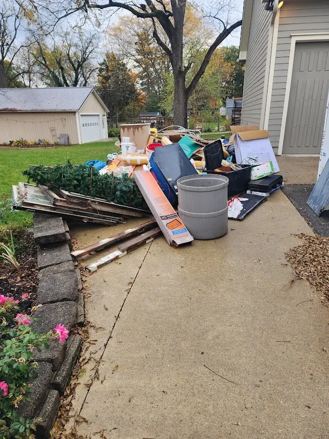 Dumpster being loaded with debris for 12 Yard Dumpster Rental in Cayce